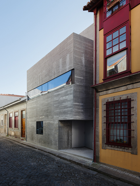 House in Porto is a narrow concrete house that falls within historical houses in Portugal