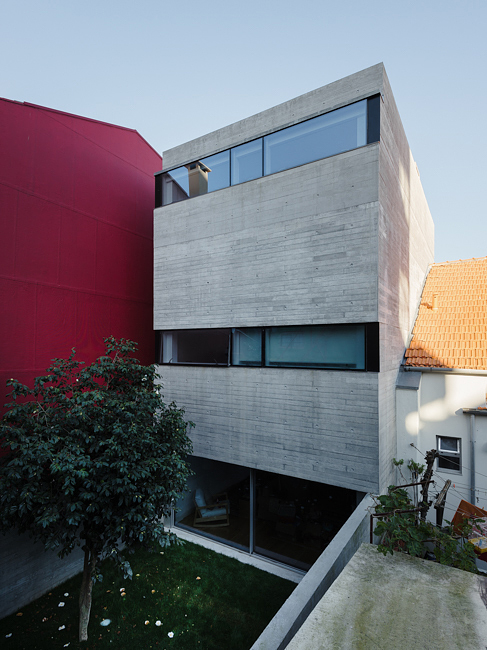 House in Porto is a narrow concrete house that falls within historical houses in Portugal