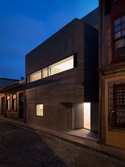 House in Porto is a narrow concrete house that falls within historical houses in Portugal