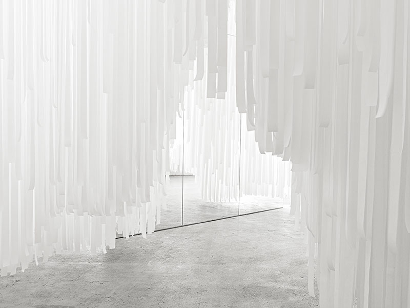Snarkitecture creates a ’’cave’’ with paper-tissued suspended waves