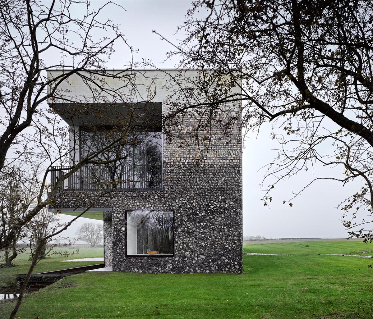 Flint house is an extension of landscape and geological extrusion referring to contemporary stone age