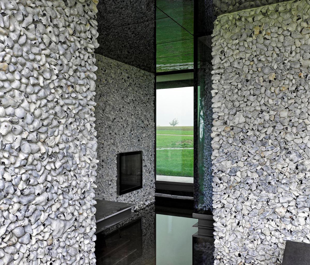 Flint house is an extension of landscape and geological extrusion referring to contemporary stone age