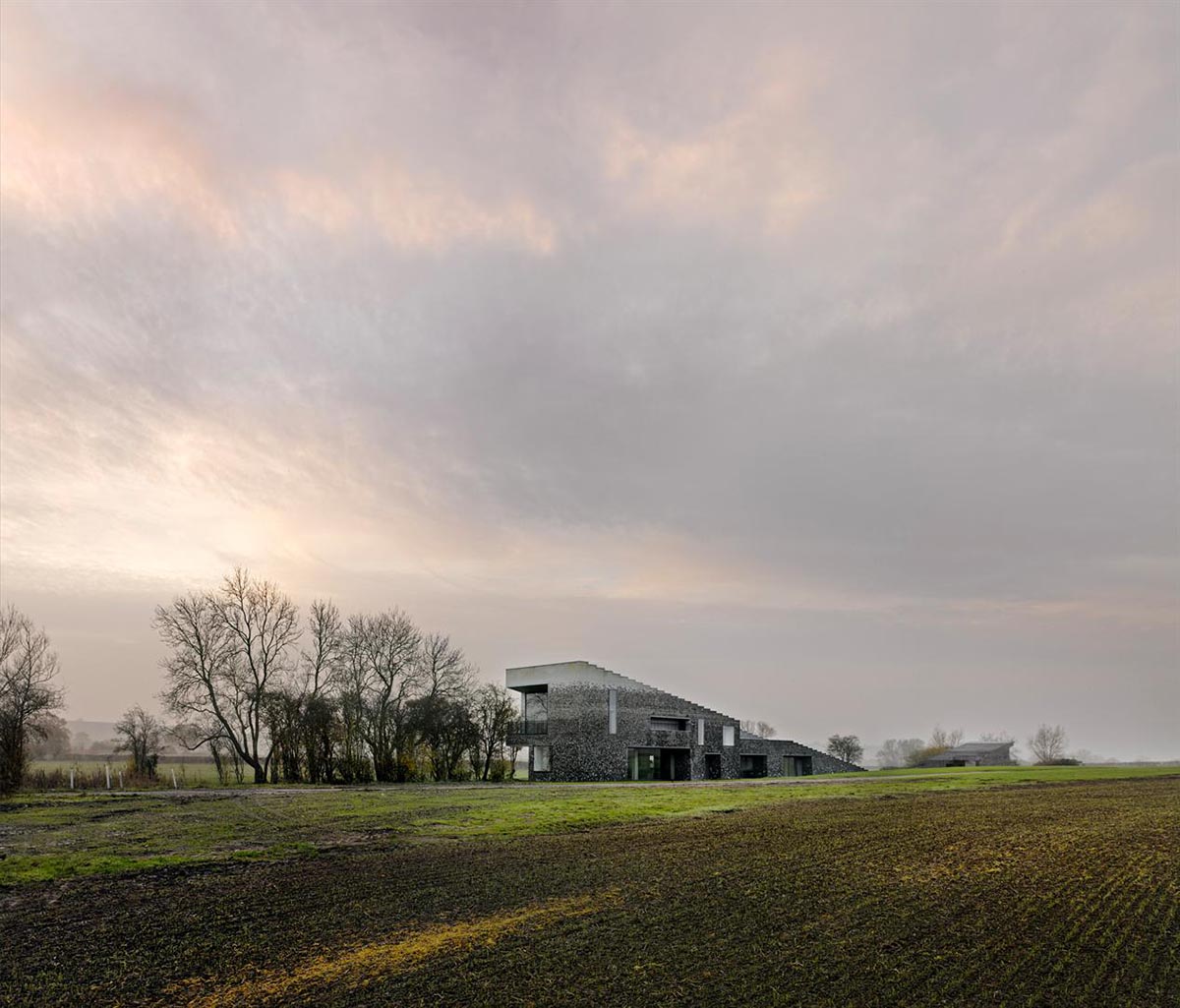 Flint house is an extension of landscape and geological extrusion referring to contemporary stone age