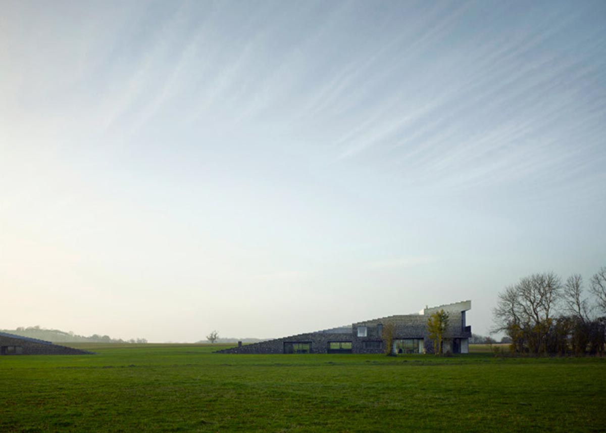 Flint house is an extension of landscape and geological extrusion referring to contemporary stone age