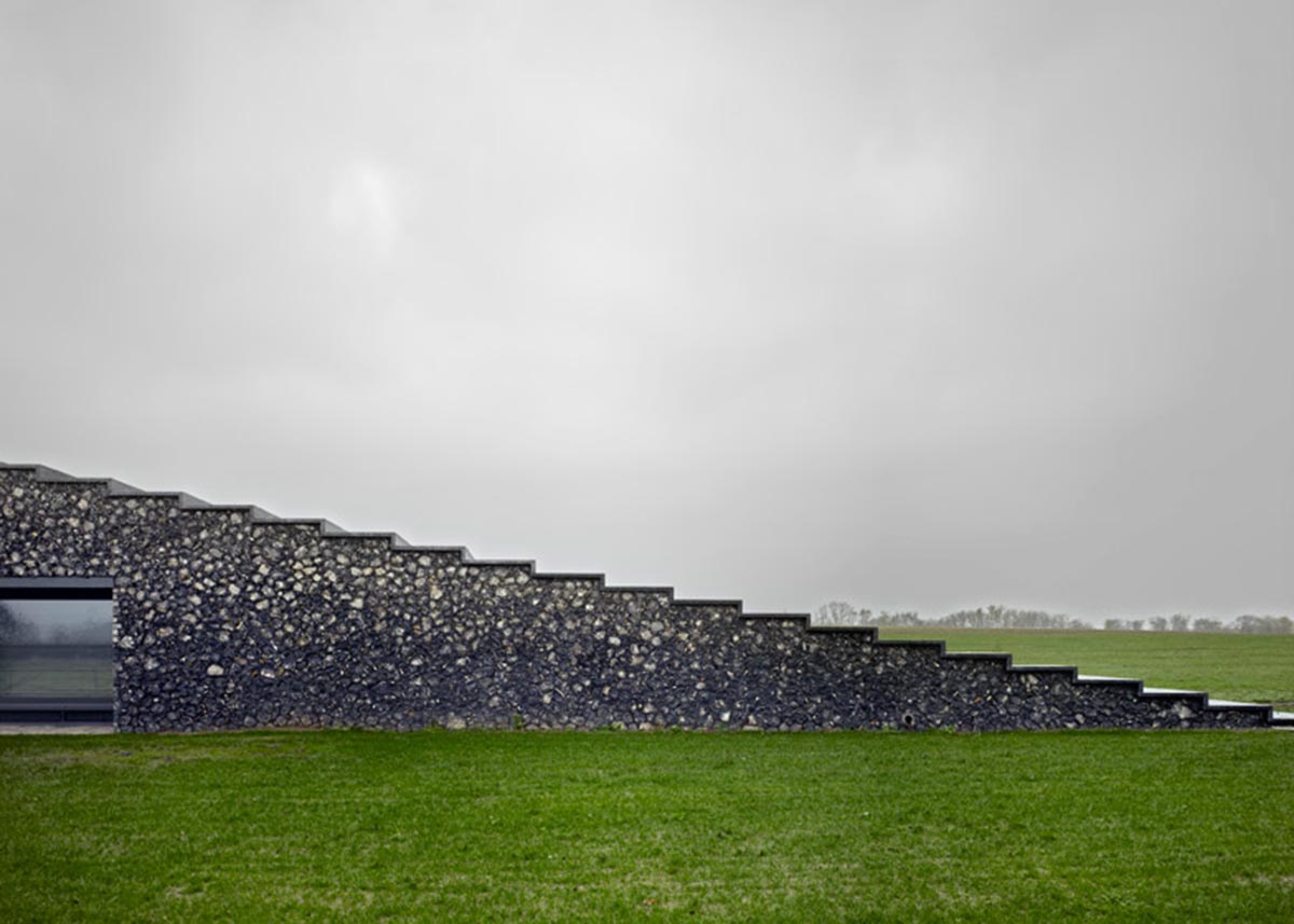 Flint house is an extension of landscape and geological extrusion referring to contemporary stone age