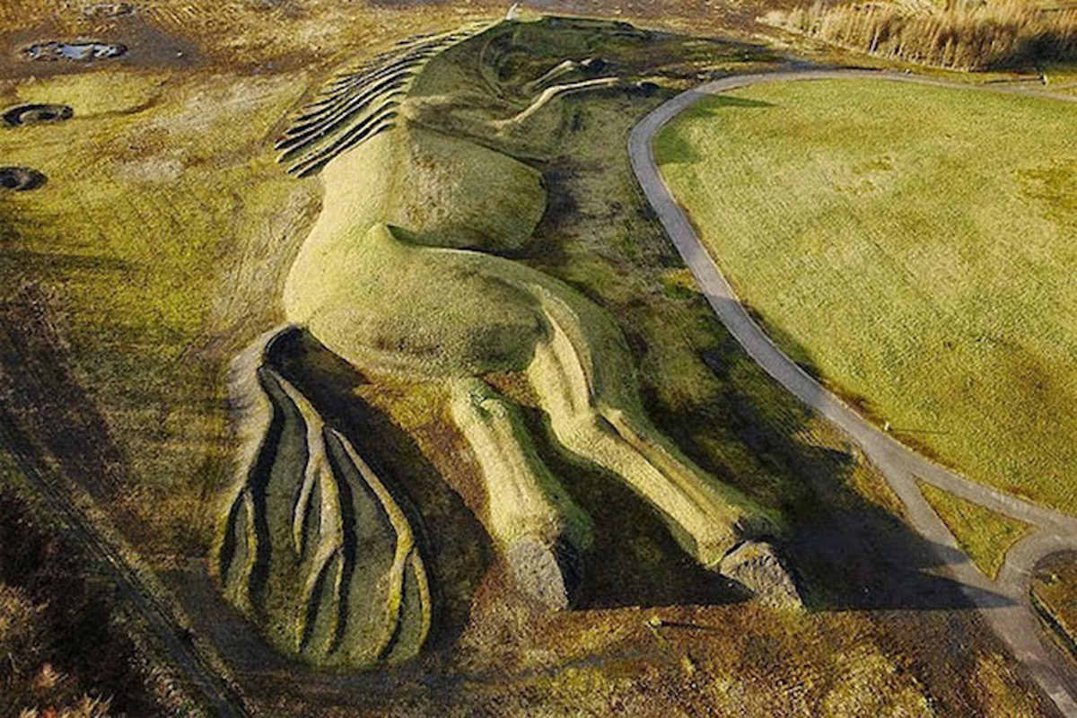 A giant horse earth sculpture integrated with natural landscape in UK