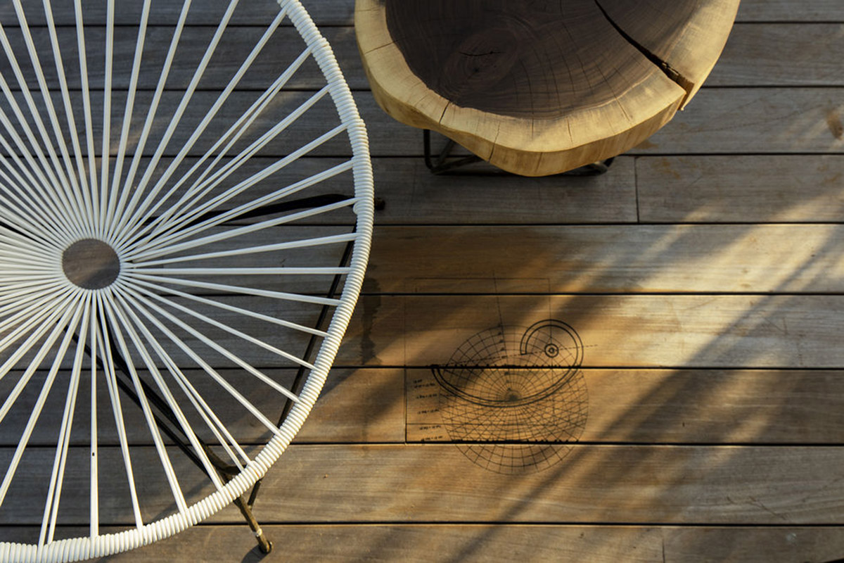 Sun Path House is a sculptural concrete house that dialogs with old bungalow houses