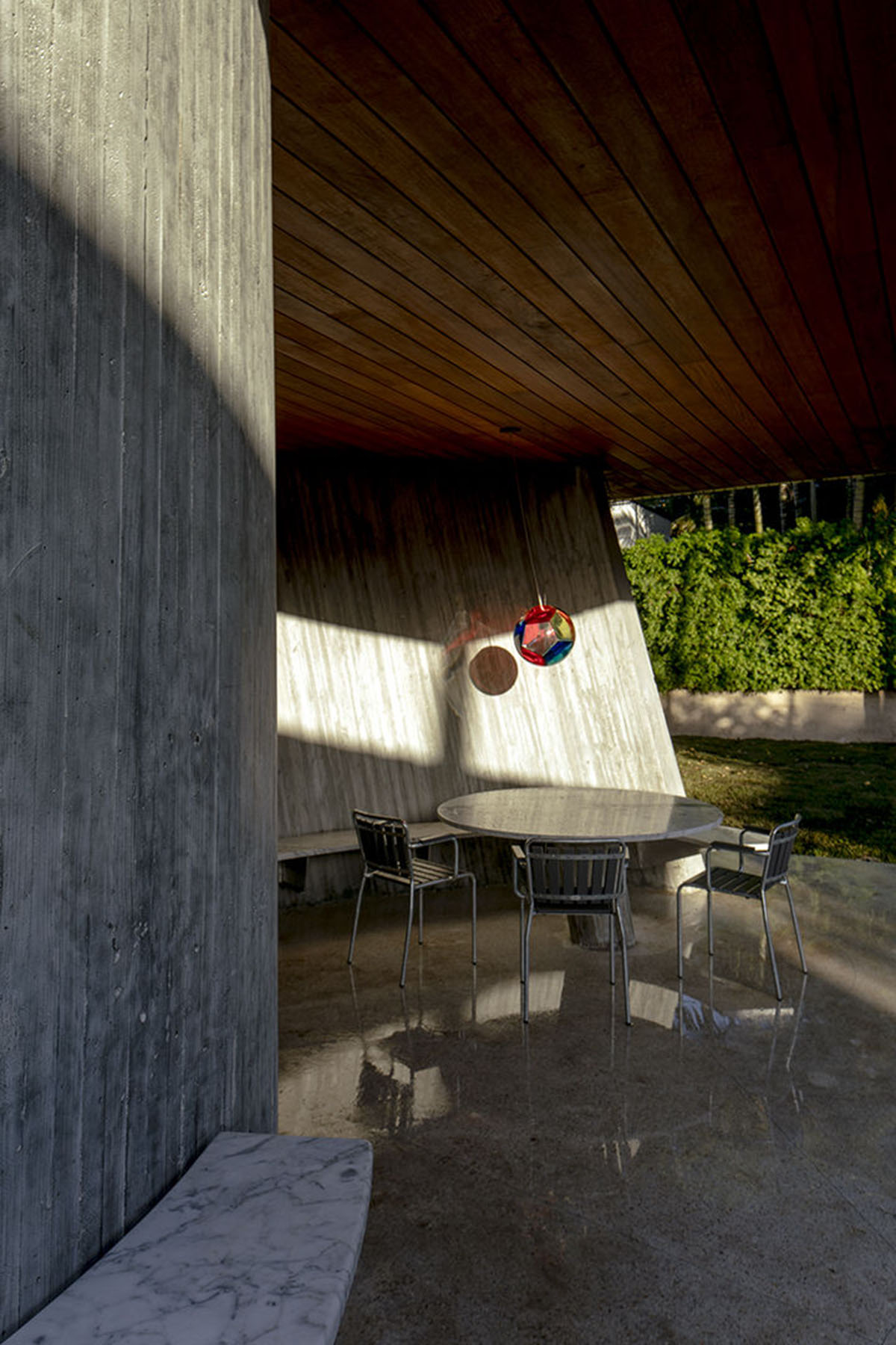 Sun Path House is a sculptural concrete house that dialogs with old bungalow houses
