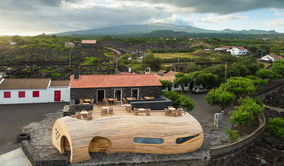A Cella Bar organically attached to the existing building designed by FCC Arquitectura+Paulo Lobo