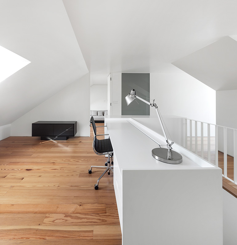 Restelo III House in Lisbon is wrapped by a white metallic fascia filtering sun light