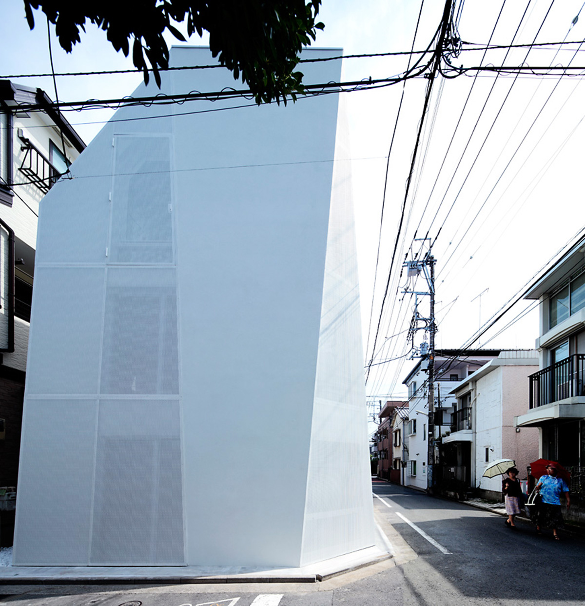 ’Tokyo House’ reflects interior living with a white abstract form emphasizing corner of the street