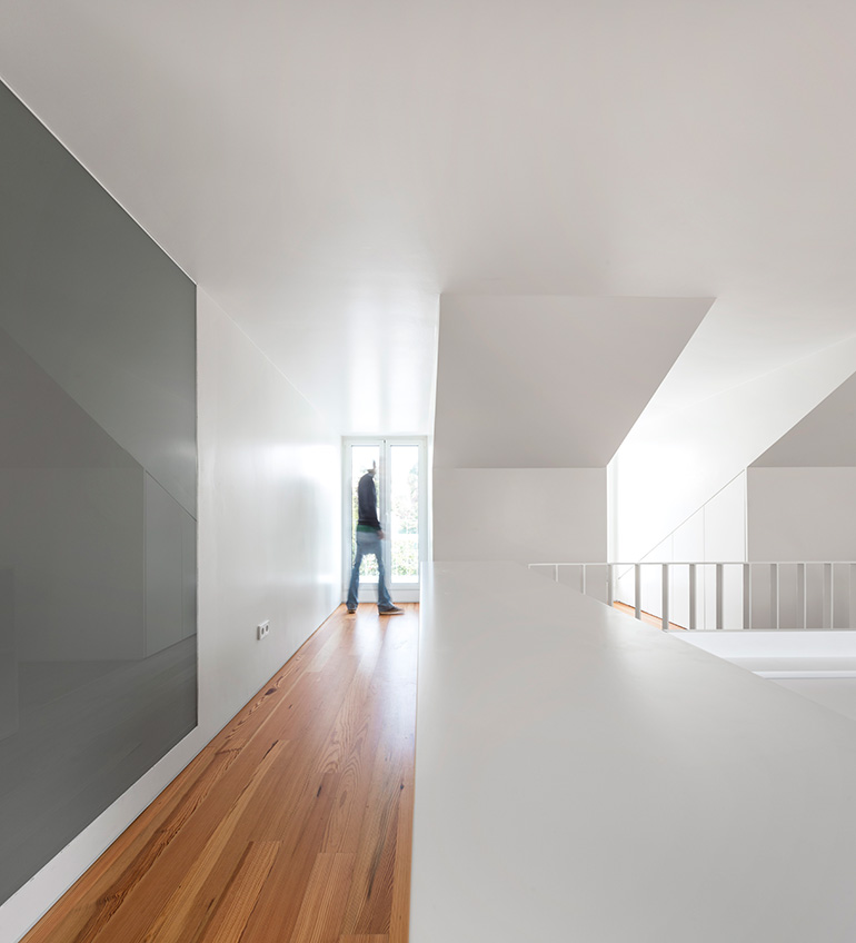 Restelo III House in Lisbon is wrapped by a white metallic fascia filtering sun light