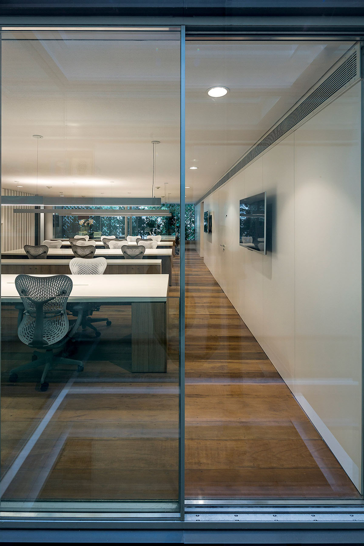 Anibal Office Building is wrapped by perforated aluminum filtering light and sound