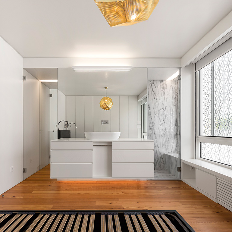 Restelo III House in Lisbon is wrapped by a white metallic fascia filtering sun light