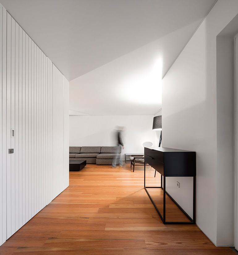 Restelo III House in Lisbon is wrapped by a white metallic fascia filtering sun light