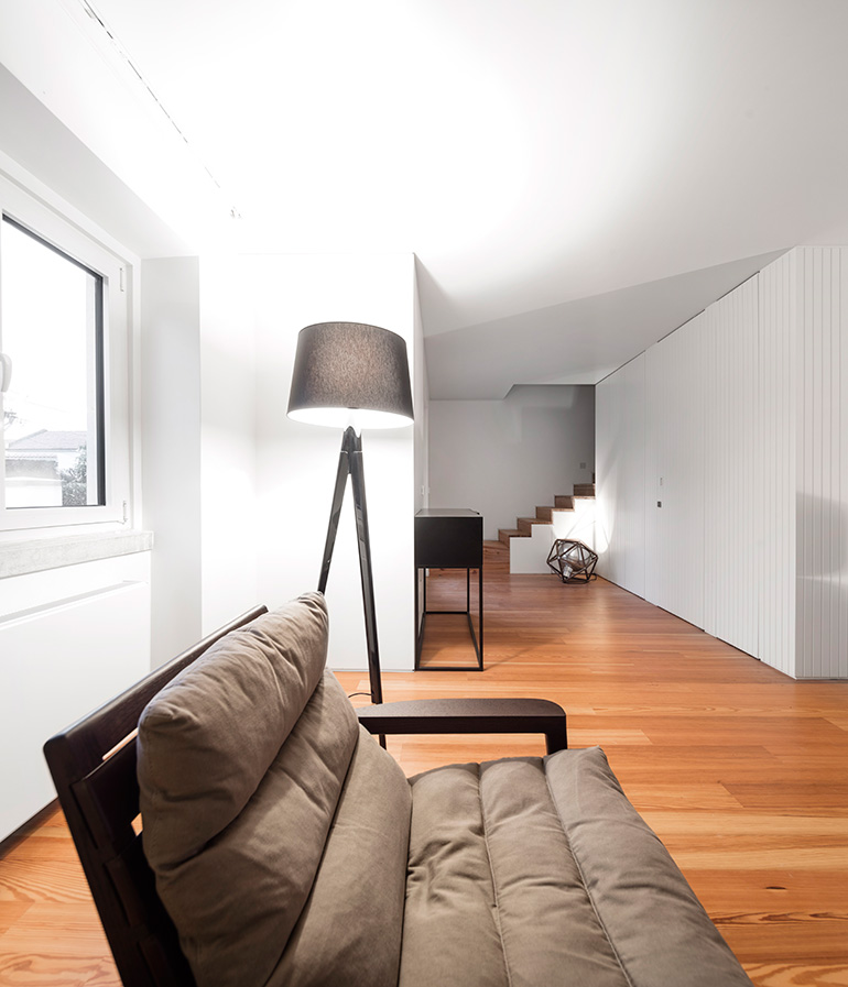 Restelo III House in Lisbon is wrapped by a white metallic fascia filtering sun light