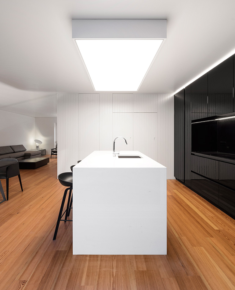 Restelo III House in Lisbon is wrapped by a white metallic fascia filtering sun light