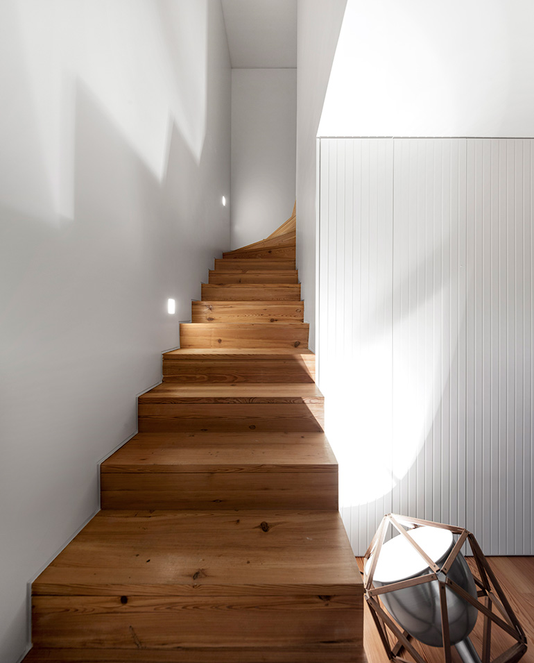 Restelo III House in Lisbon is wrapped by a white metallic fascia filtering sun light