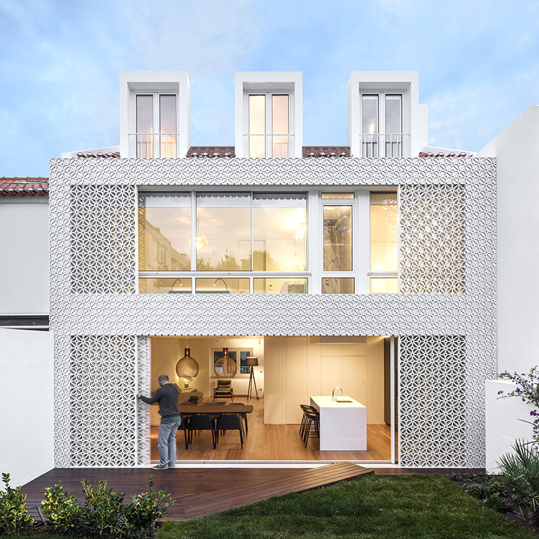 Restelo III House in Lisbon is wrapped by a white metallic fascia filtering sun light