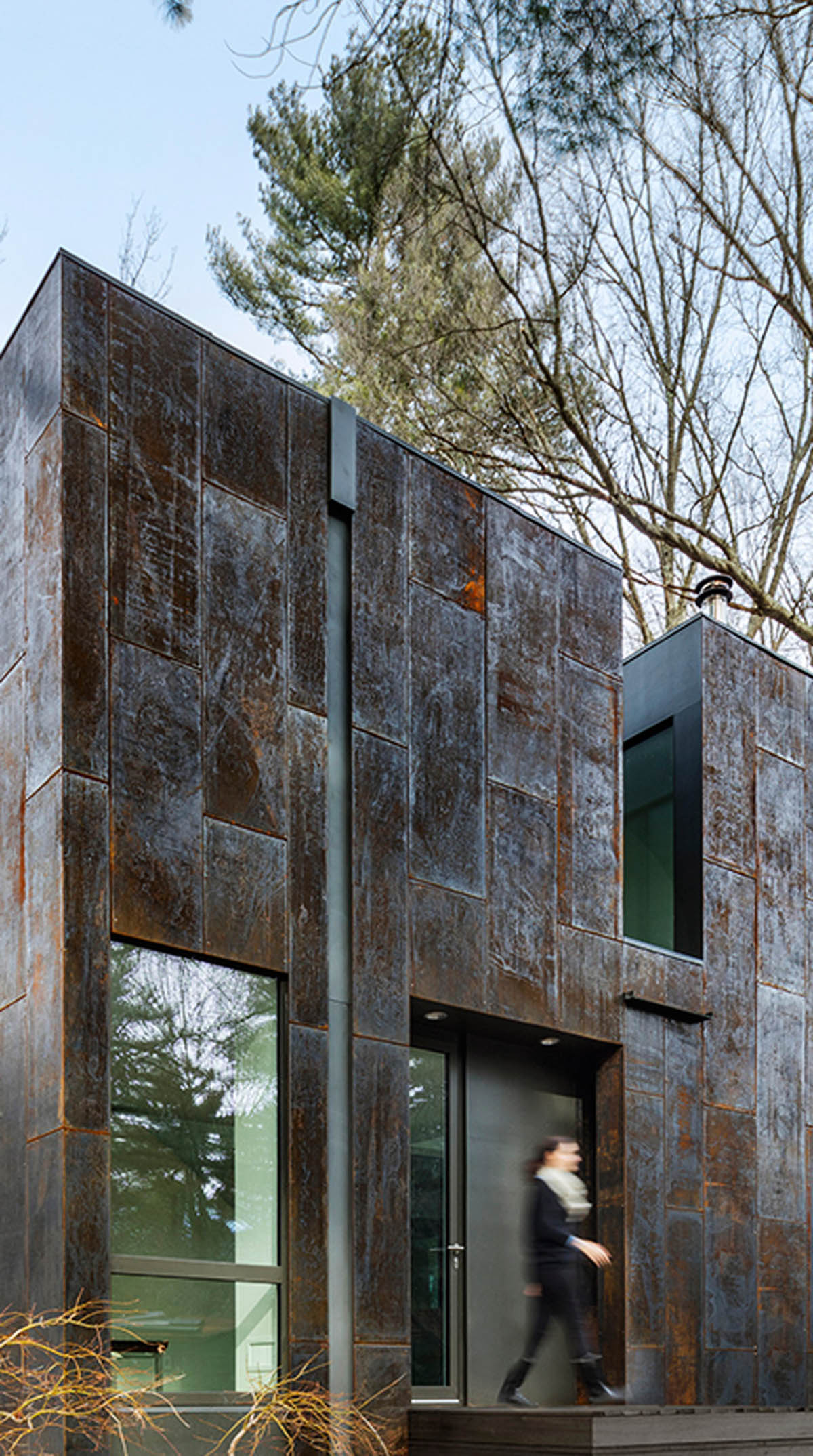 Merge Architects clads this family house with tree-trunk hue weathering steel panels in Lexington