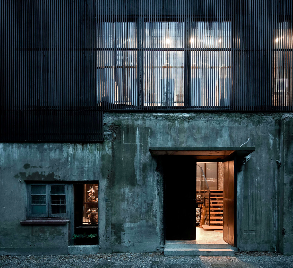 A red cedar grill placed on mottled worn walls of Ceramic House to preserve authenticity