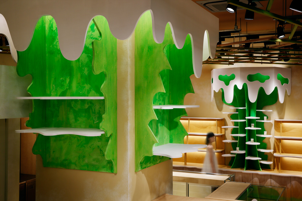 Moriyuki Ochiai Architects combines milky and forested tones with energetic patterns in MOMOM shop
