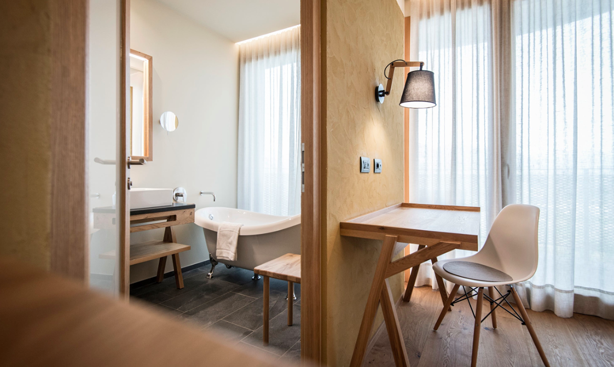 NOA’s Hubertus Hotel in Italy features cantilevering pool looking natural topography of the town