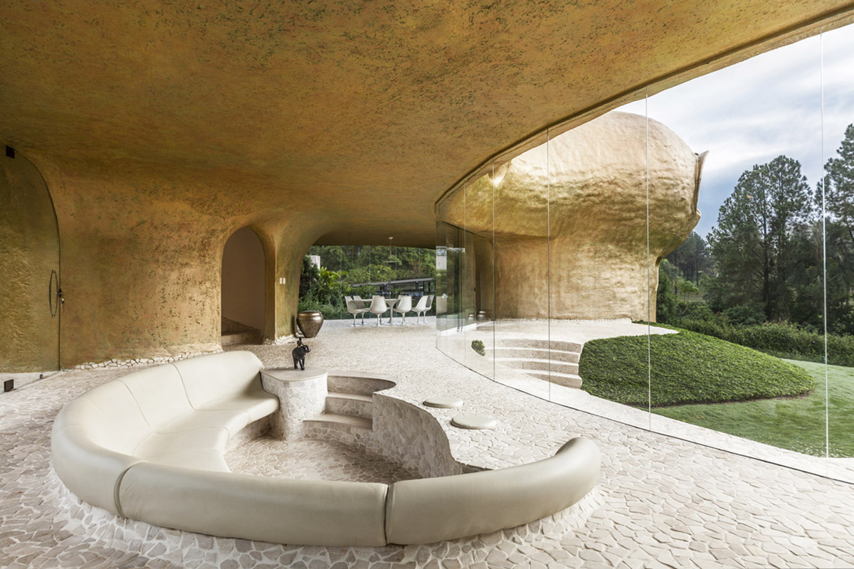 Javier Senosiain&rsquo;s Amoeba House supported on three legs and painted with gold+copper patina