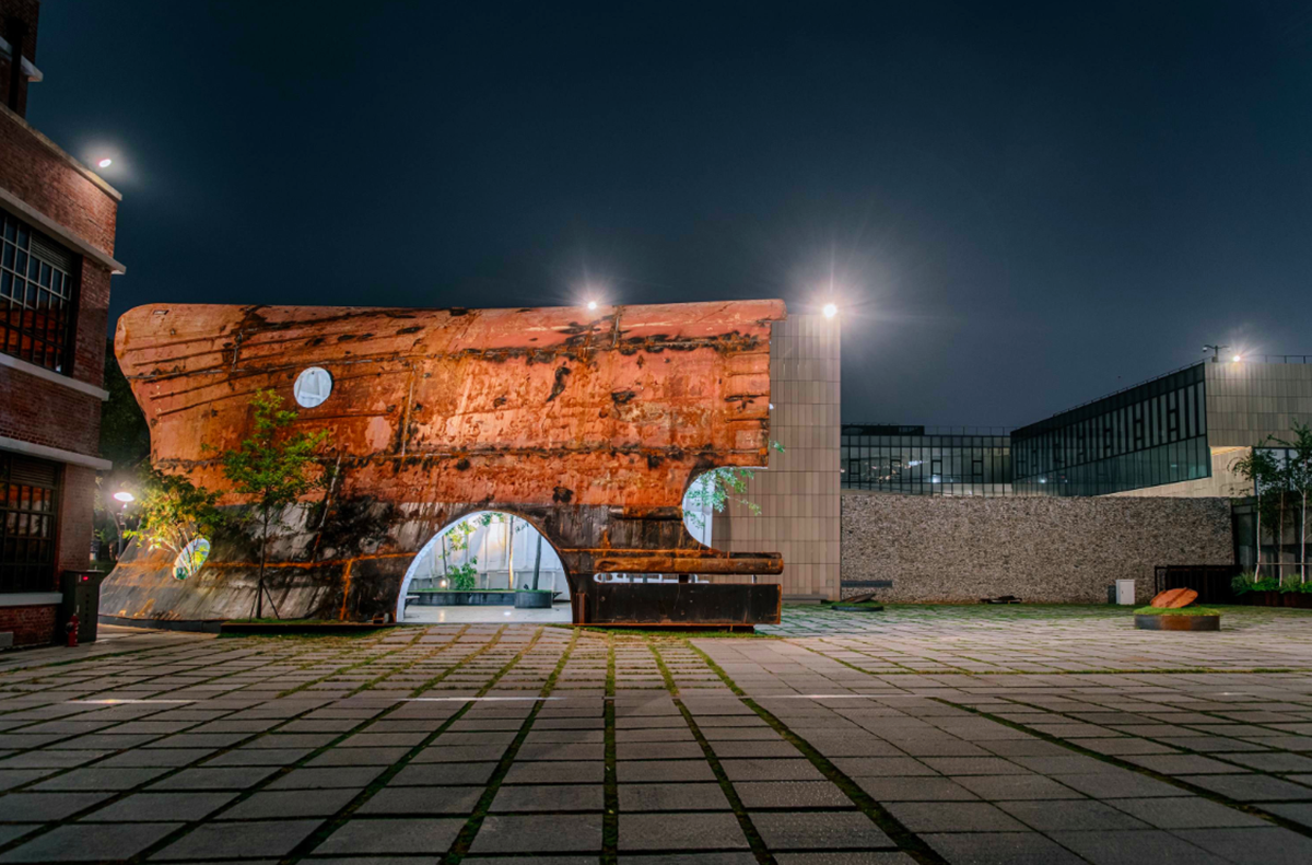 This upside down massive metal pavilion is made of recycled steel parts from an old ship by Shinslab