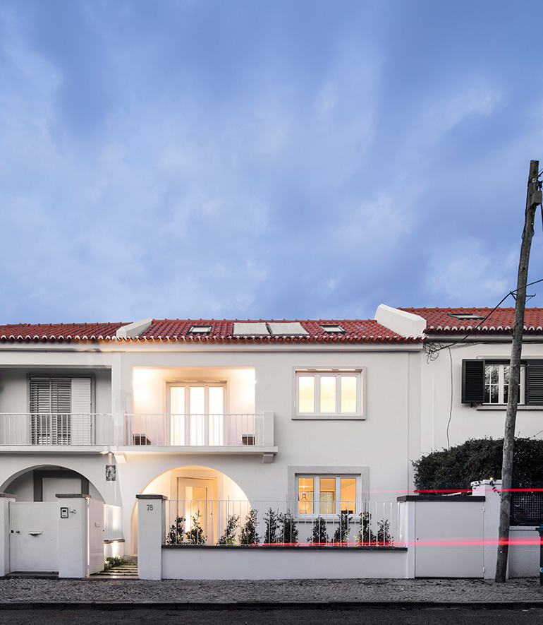 Restelo III House in Lisbon is wrapped by a white metallic fascia filtering sun light