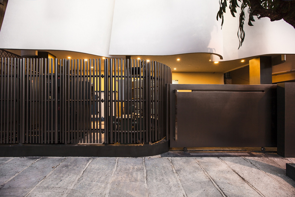 Cadence folds KMYF Health Clinic white facade with masonry techniques adjacent to Indian Temple