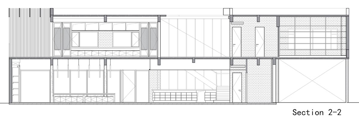 A red cedar grill placed on mottled worn walls of Ceramic House to preserve authenticity