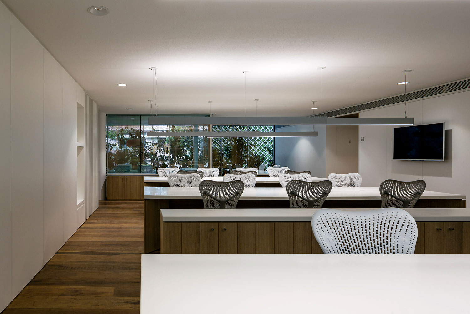 Anibal Office Building is wrapped by perforated aluminum filtering light and sound