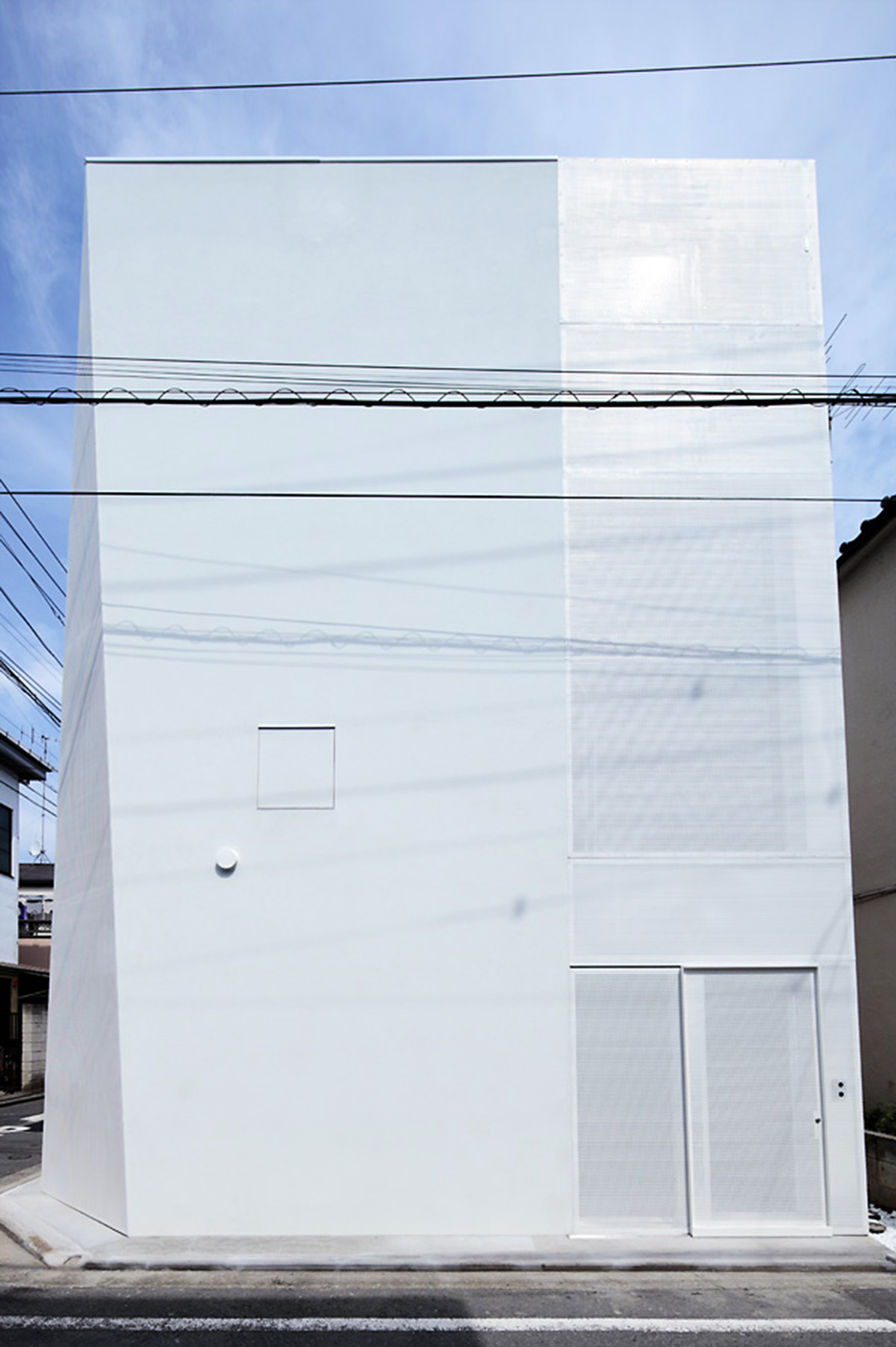 ’Tokyo House’ reflects interior living with a white abstract form emphasizing corner of the street