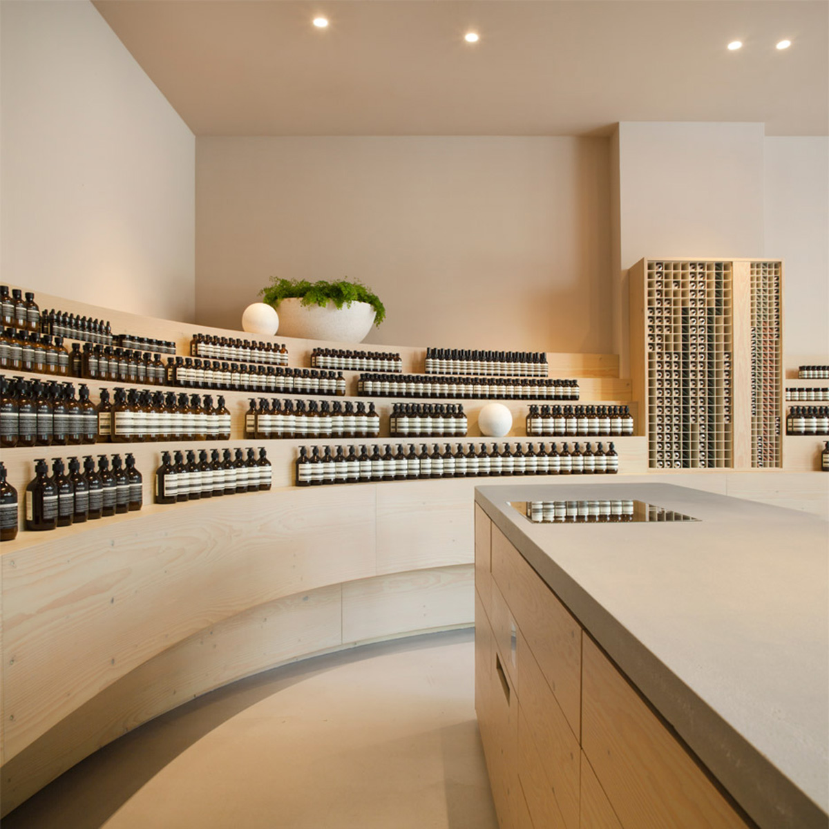 Snøhetta designed curvilinear wooden shelves with pastel colours for Aesop’s new Düsseldorf store