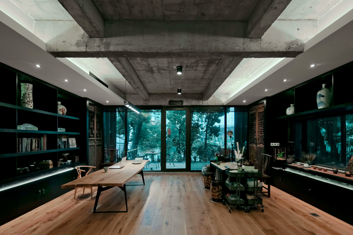 A red cedar grill placed on mottled worn walls of Ceramic House to preserve authenticity