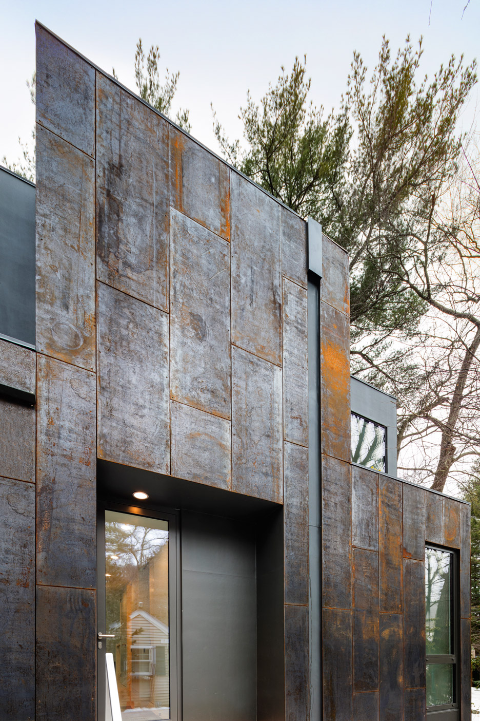 Merge Architects clads this family house with tree-trunk hue weathering steel panels in Lexington