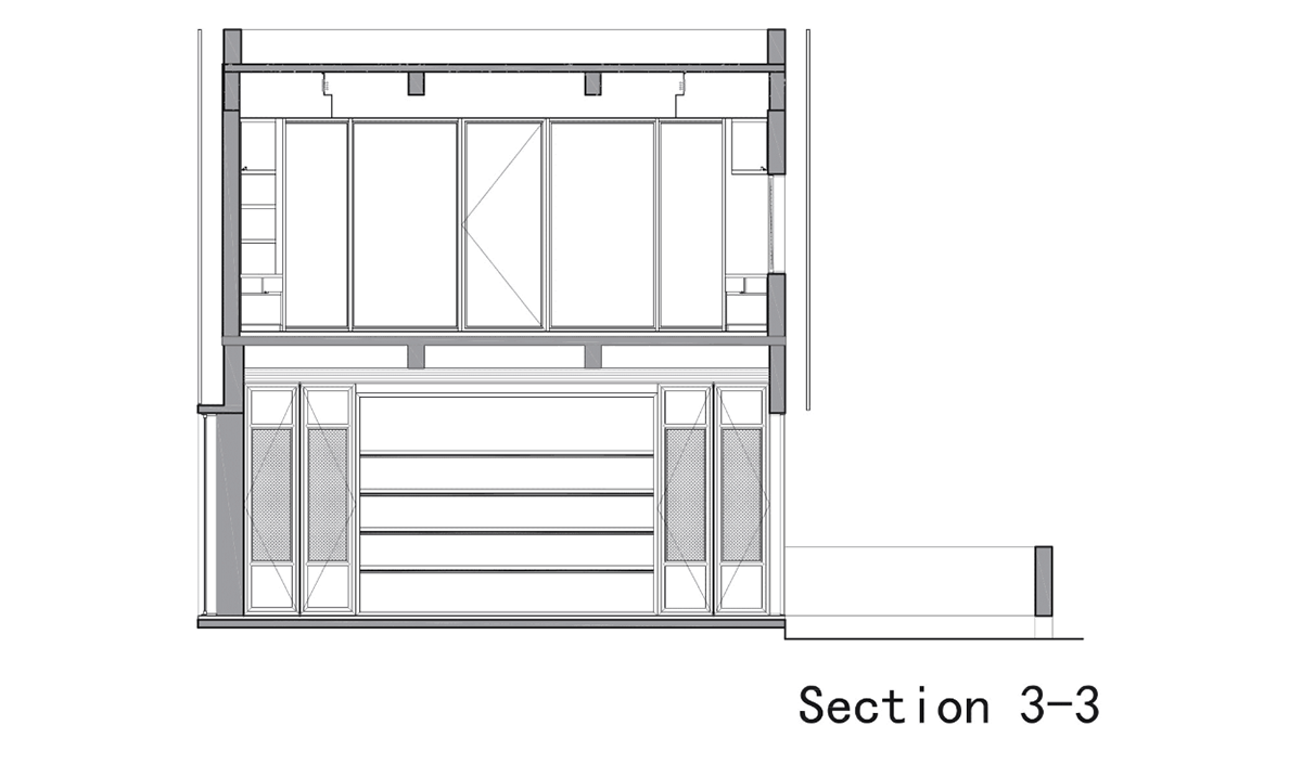 A red cedar grill placed on mottled worn walls of Ceramic House to preserve authenticity