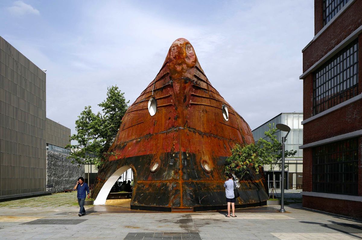 This upside down massive metal pavilion is made of recycled steel parts from an old ship by Shinslab