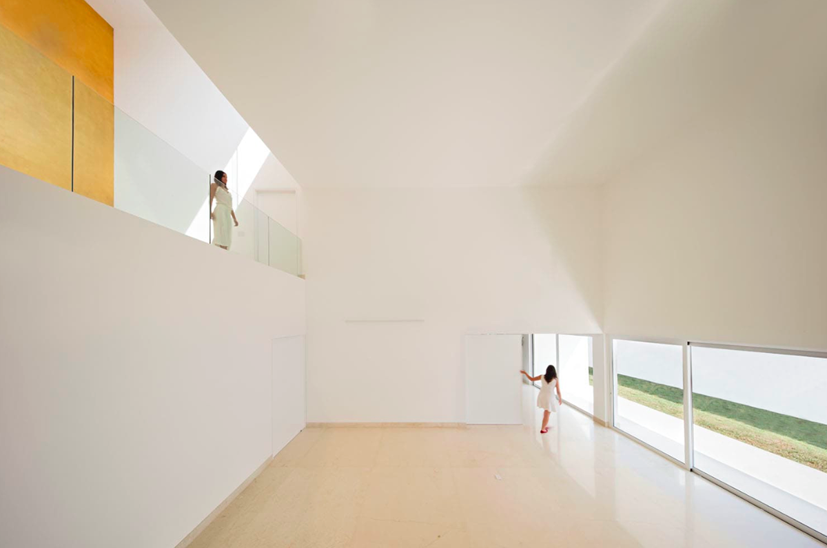 A nude-white house in Mexico filled with natural light and golden hue to create your dream house