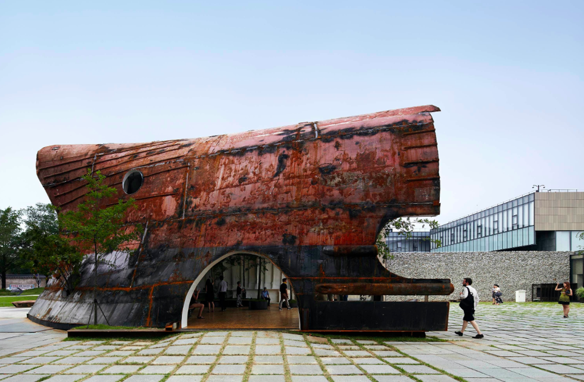 This upside down massive metal pavilion is made of recycled steel parts from an old ship by Shinslab