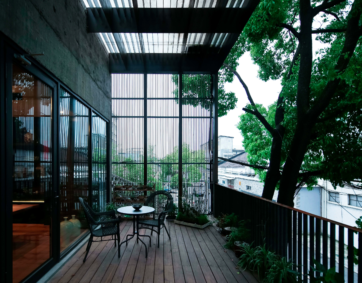 A red cedar grill placed on mottled worn walls of Ceramic House to preserve authenticity