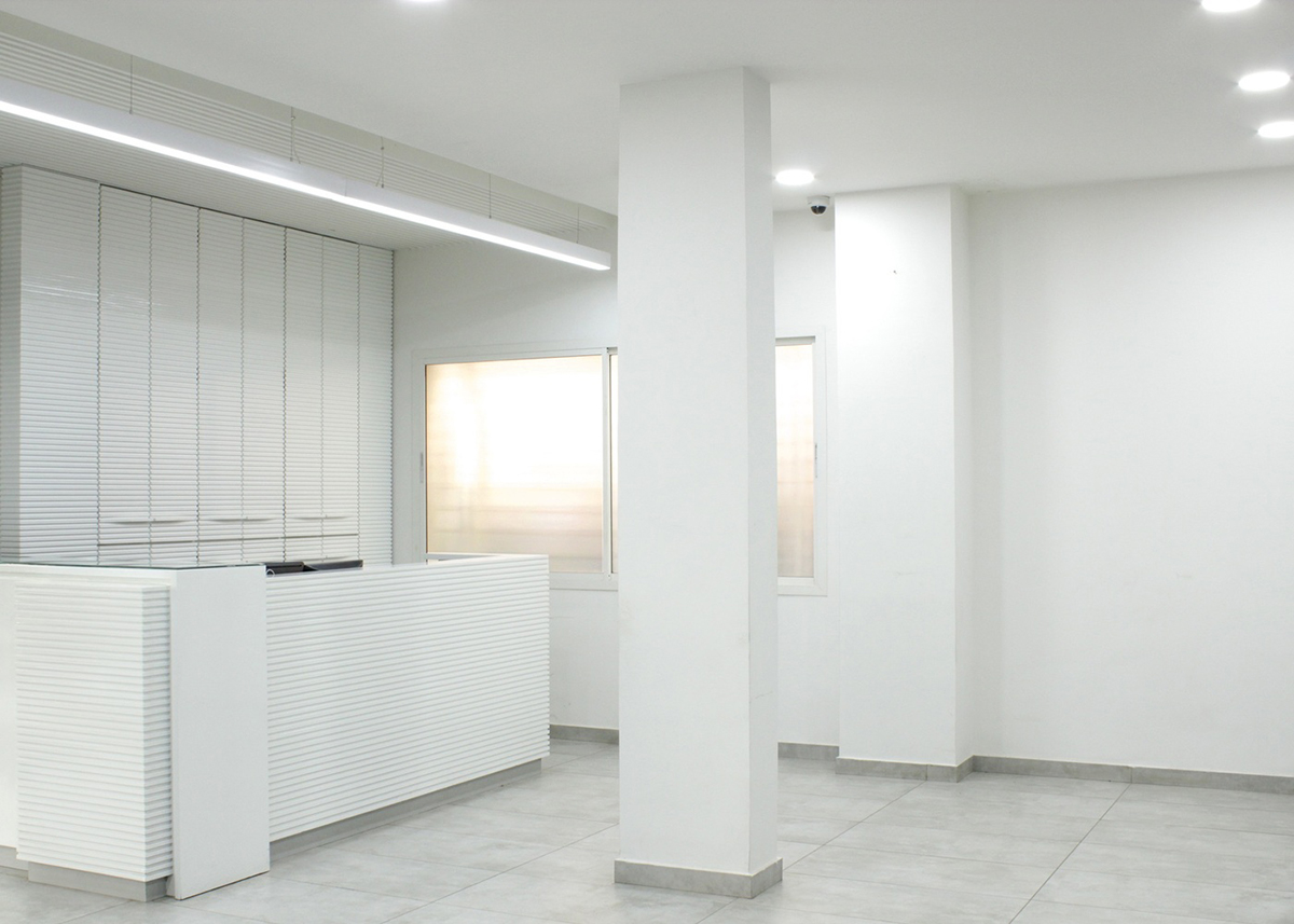 Cadence folds KMYF Health Clinic white facade with masonry techniques adjacent to Indian Temple