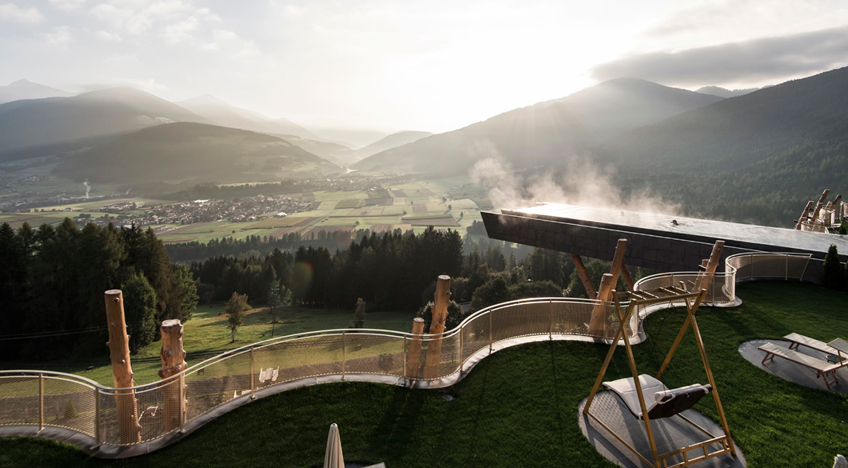 NOA’s Hubertus Hotel in Italy features cantilevering pool looking natural topography of the town