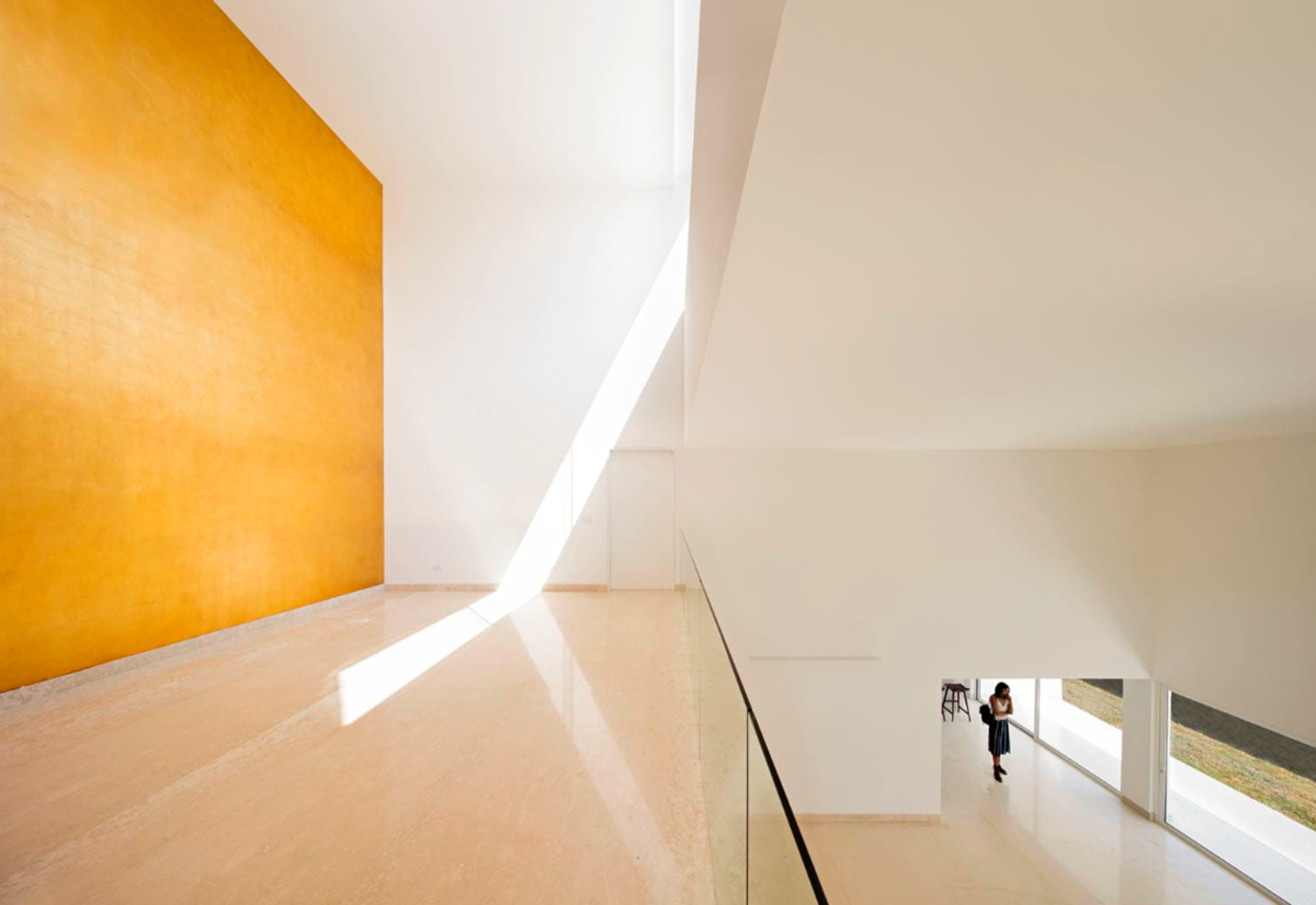A nude-white house in Mexico filled with natural light and golden hue to create your dream house