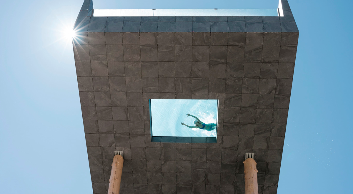 NOA’s Hubertus Hotel in Italy features cantilevering pool looking natural topography of the town