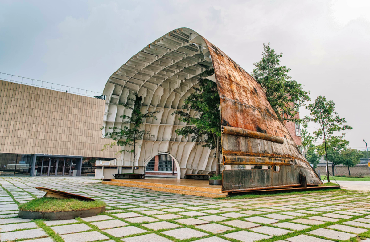 This upside down massive metal pavilion is made of recycled steel parts from an old ship by Shinslab