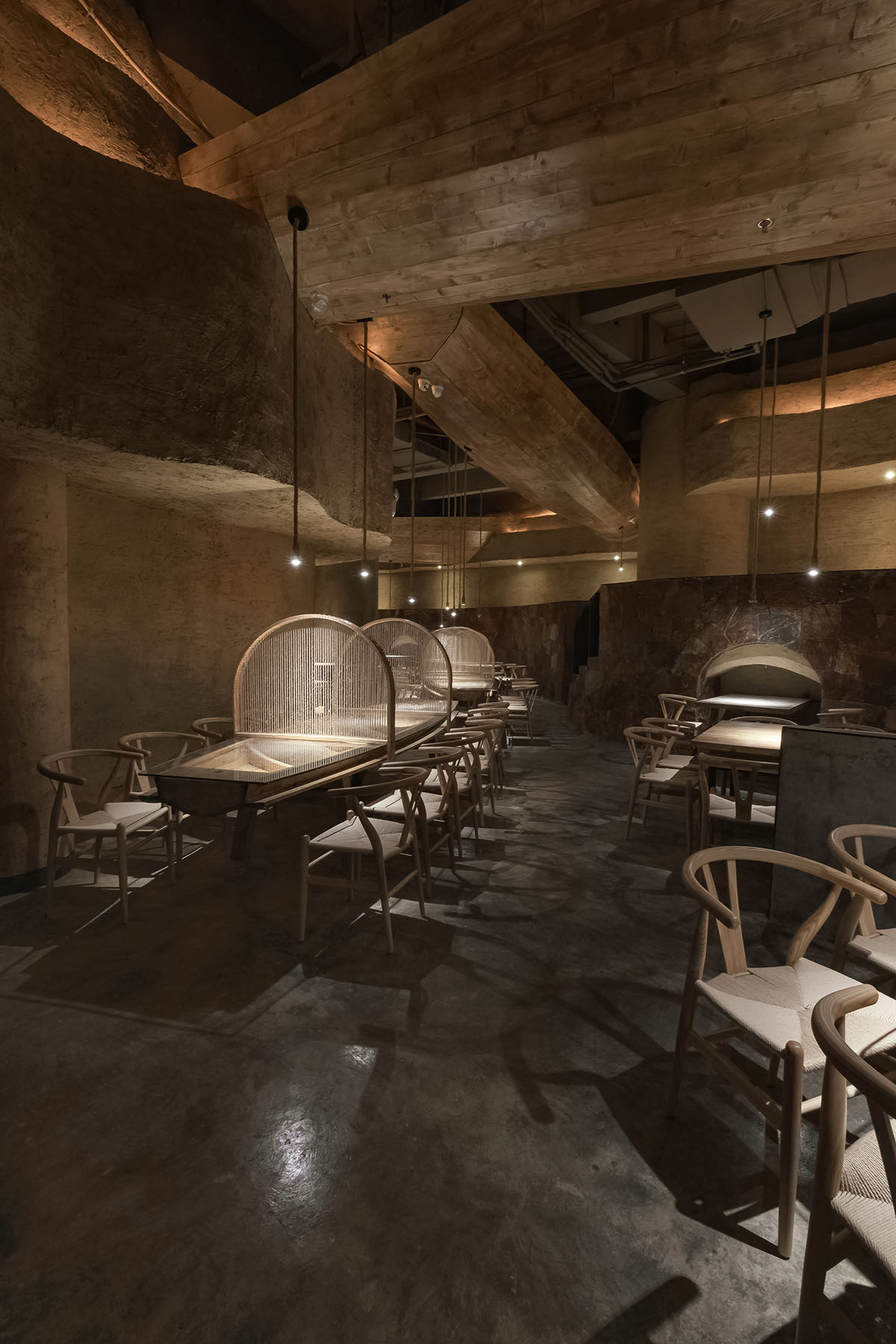 Designer Xu Xu-Jun hangs plenty of wooden-boats from the ceiling of Pu Zao Restaurant in China