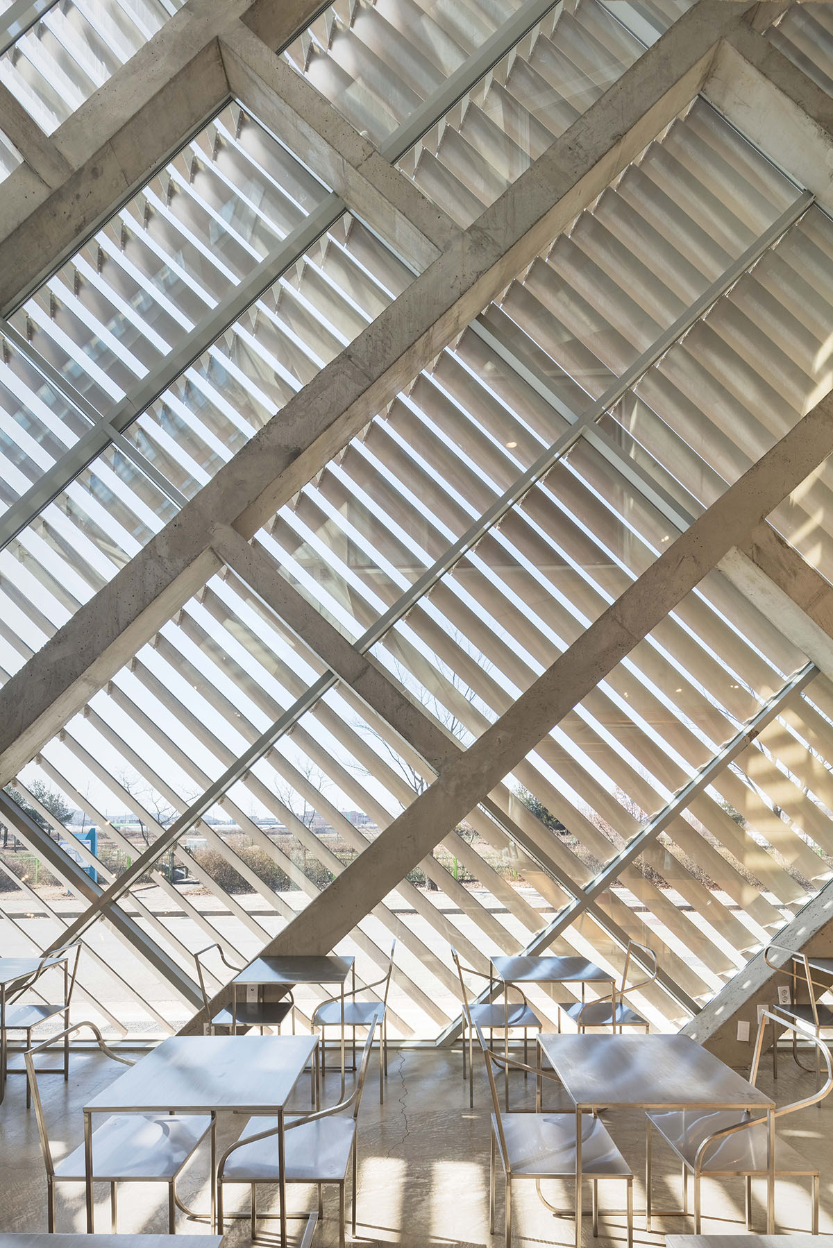 AND wraps a cafe/residence in South Korea with diagonal metal louvers