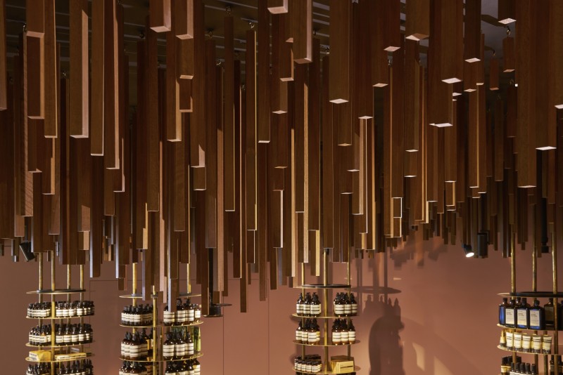 Snøhetta suspends ’a timber-forest’ from the ceiling of Aesop ION Store in Singapore